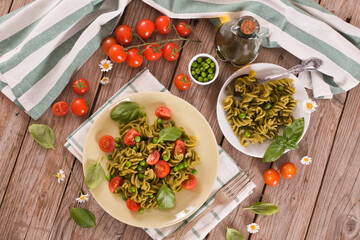 Fusilli pasta with cherry tomatoes and peas.
