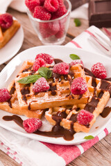 Waffles with raspberries and chocolate cream.
