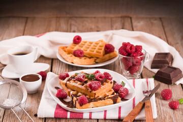 Waffles with raspberries and chocolate cream.