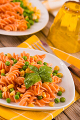 Fusilli pasta with peas and sweet corn.