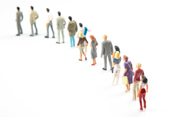 miniature people. different people stand in line one after another on a white background. communication of society of different generations