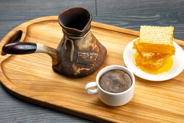 Fototapeta na wymiar fresh hot coffee with turkey and honeycomb on a kitchen wooden board. useful vitamin food