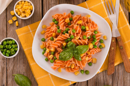Fusilli pasta with peas and sweet corn.