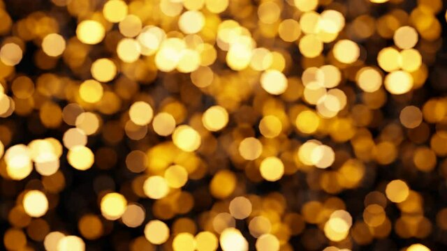 Realistic looping 3D animation of the shining yellow light particles circular bokeh rendered in UHD as motion background