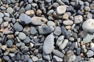 Fototapeta na wymiar Pebble rocks on lake shore.