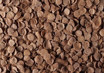 Crunchy corn flakes with cocoa, cereal, muesli pile background, top view