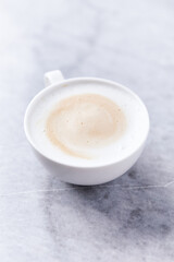 Coffee with milk on bright stone background. Close up.	