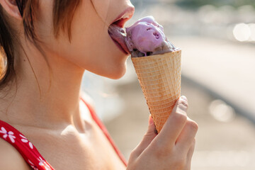 Young woman licking an icecream