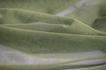 textured fabric khaki mesh close-up falls in waves