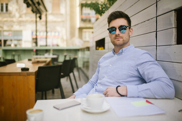 Portrait of a young caucasian businessman in coffeeshop 
