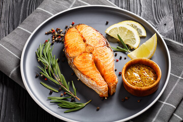 baked salmon steak on a plate, top view