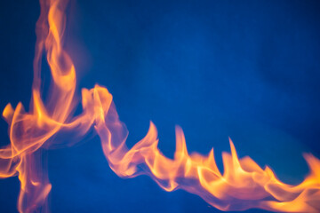 Blurred background texture of orange fire on blue background