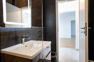 modern bathroom with dark furniture and spotlights