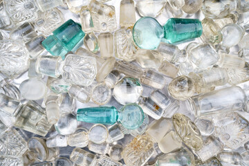 Closeup top view of lot of colored antique glass bottle stoppers from decanters and flasks with traces of use. 