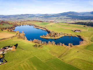 Panorama aerial image of the Gerzensee Lake and village in Bern Oberland, Switzerland