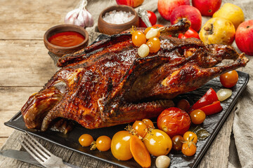 Whole roast duck stuffed with apples. Poultry served with pickled vegetables