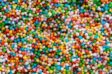 Fototapeta na wymiar Thousands sprinkles tiny sugar beads for decorating cakes and desserts background.