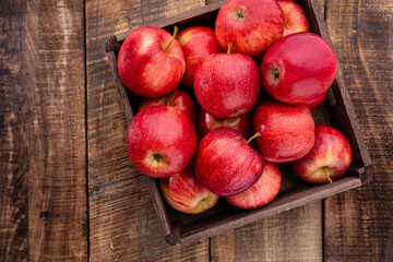 Ripe red apples in wooden box. Top view with space for your text.