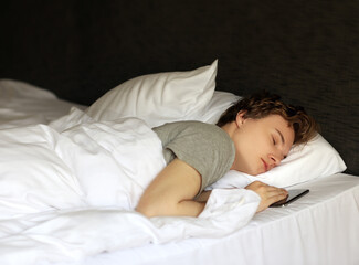 young sleeping man lying on the bed