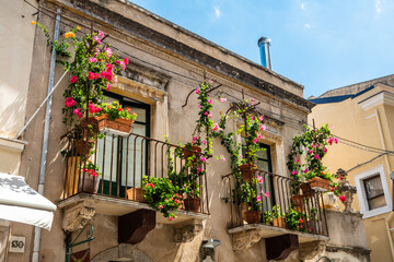 Typical Sicilian balcony in Taormina full of flowers and decorations