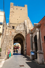 Fototapeta na wymiar Clock tower and middle door in Taormina, Italy