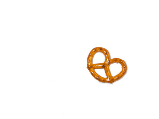 Small pretzel on a white background. Flour product. Baking for tea. Crispy biscuit.