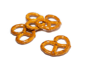 Small pretzels on a white background. Flour products. Baking for tea. Crispy biscuits.