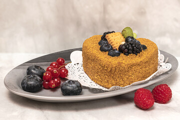 Delicious cace decorated with raspberries, bluberries and brush red currant