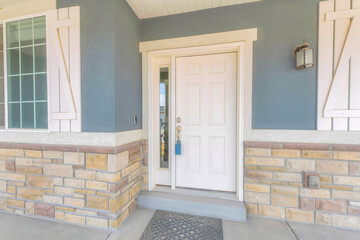 White front door at the home entrance with sidelight and lockbox