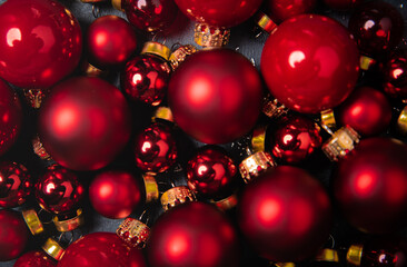 Red christmas balls on the black stone background