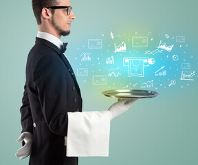 Handsome young waiter in tuxedo holding money icons on tray