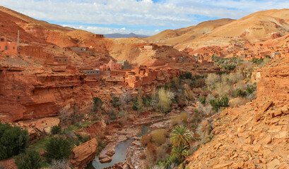 Fototapeta premium .Traditional Berber village in the Atlas mountains, traditional mountain houses and a canyon with a small river