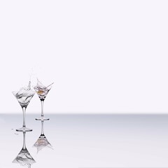 A pair of cocktail glasses with a splash of a drink and a single olive on a stick