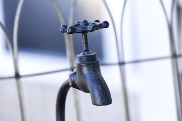 Close up outside old fashioned black water faucet