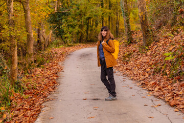Fototapeta premium A young woman on a path to Mount Erlaitz in autumn in the town of Irun, Gipuzkoa. Basque Country