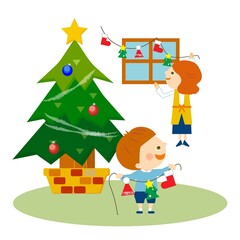 クリスマスツリーと飾り付けする親子