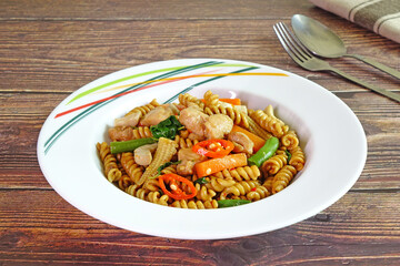 Drunken Fusilli with chicken, Thai style pasta. Thai Spicy Fusilli with chicken and herbs. Fusion food, Thai - Italian cuisine