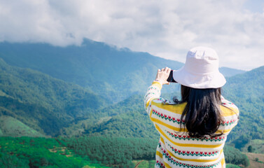 woman taking pictures with smartphone traveling mountain nature