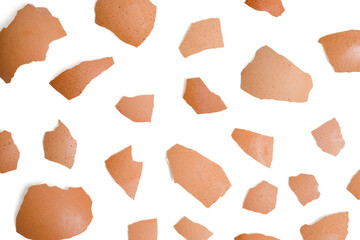 Top view group of broken eggshells stacked pattern on white background.