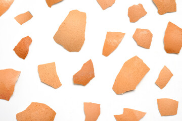 Top view group of broken eggshells stacked on white background.