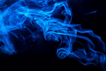 Abstract colored smoke hookah on dark background. Texture. Art Design element. Personal vaporizers fragrant steam. Concept of alternative non-nicotine smoking. E-cigarette. Blurry image, soft focus