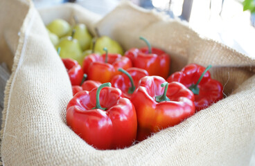 Red bell bell pepper in a burlap bag