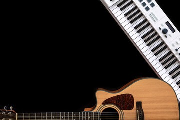 Musical background with acoustic guitar and musical keys on black, copy space.
