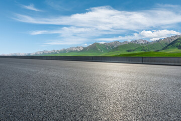 Asphalt highway and mountain under blue sky.Empty road and mountain nature background.