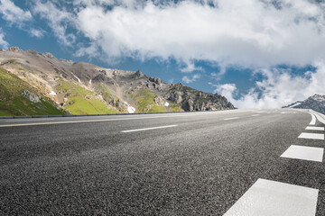 Asphalt highway and mountain under blue sky.Empty road and mountain nature background.