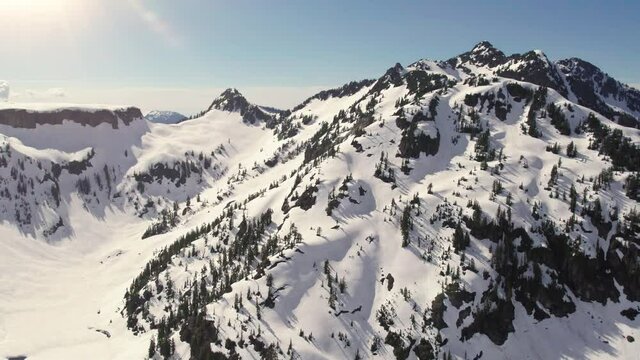Drone Rising Over Rugged Mountain Terrain with Spring Snow Melting