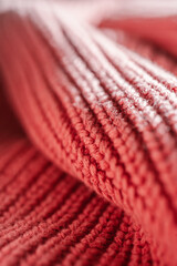 Knitted texture of a pink sweater or scarf close-up.