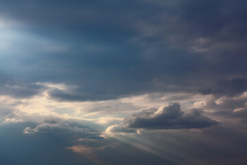 Dim light sky . Sun rays at grey clouds