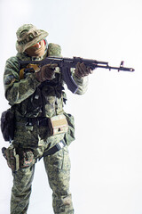 Members of the special purpose unit. A Russian special forces soldier with assault rifle aiming from a machine gun on a white background