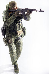 Members of the special purpose unit. A Russian special forces soldier with assault rifle aiming from a machine gun on a white background